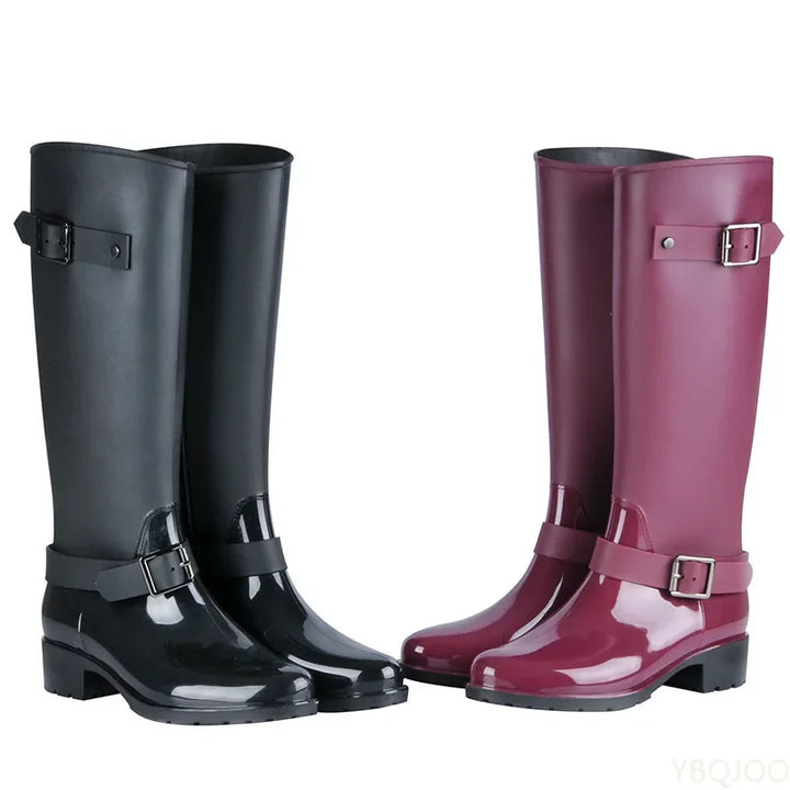 Stylish women's knee-high waterproof rain boots with elegant buckles & block heels for wet seasons.