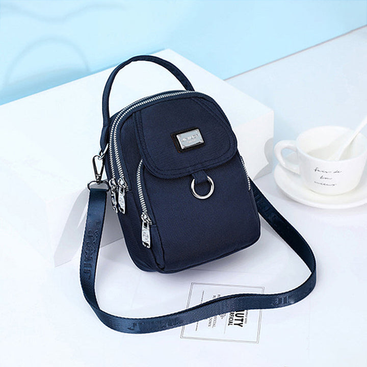 Side view of women's waterproof oxford crossbody bag, slim profile