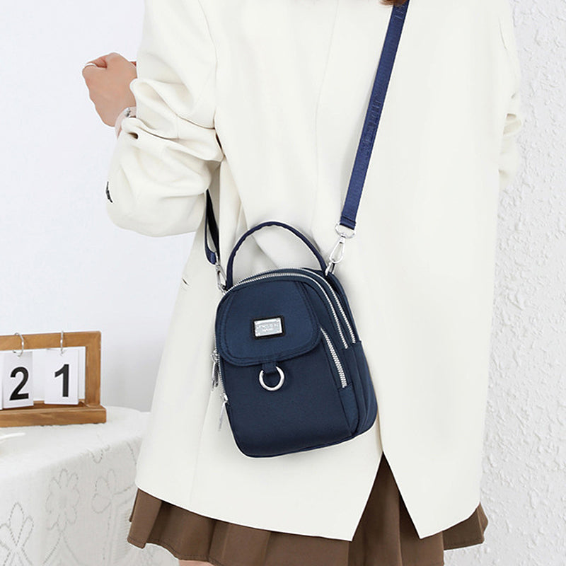 Front view of women's oxford waterproof shoulder bag, secure zipper closure