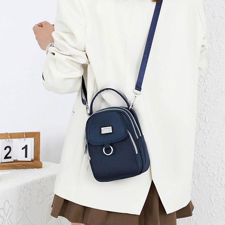 Front view of women's oxford waterproof shoulder bag, secure zipper closure