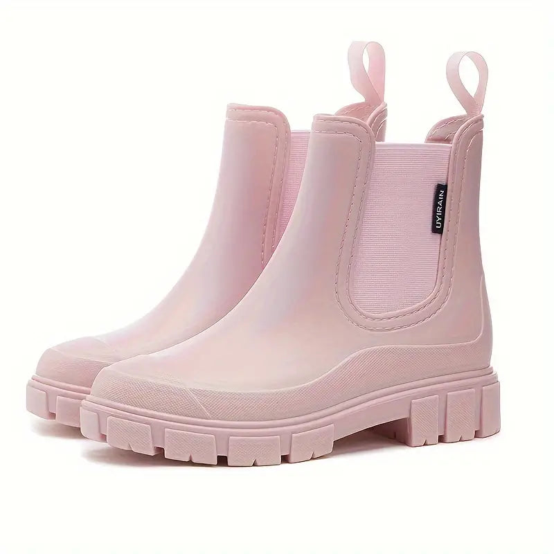 Pair of women's waterproof black Chelsea ankle boots, slip-on style, casual yet durable footwear