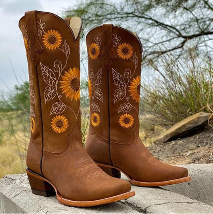 Fashionable women's sunflower embroidered Western boots. Pointed toe & mid-calf cut for a chic country look.