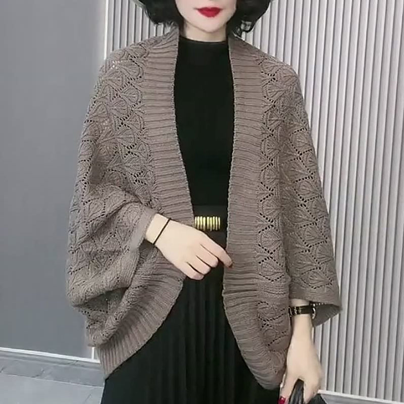 Side view of the women's white knit diamond hollow short cardigan, highlighting the batwing sleeve.