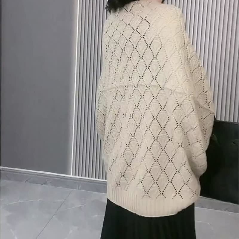 Front view of a women's knit diamond hollow short shawl cardigan, a chic versatile top.