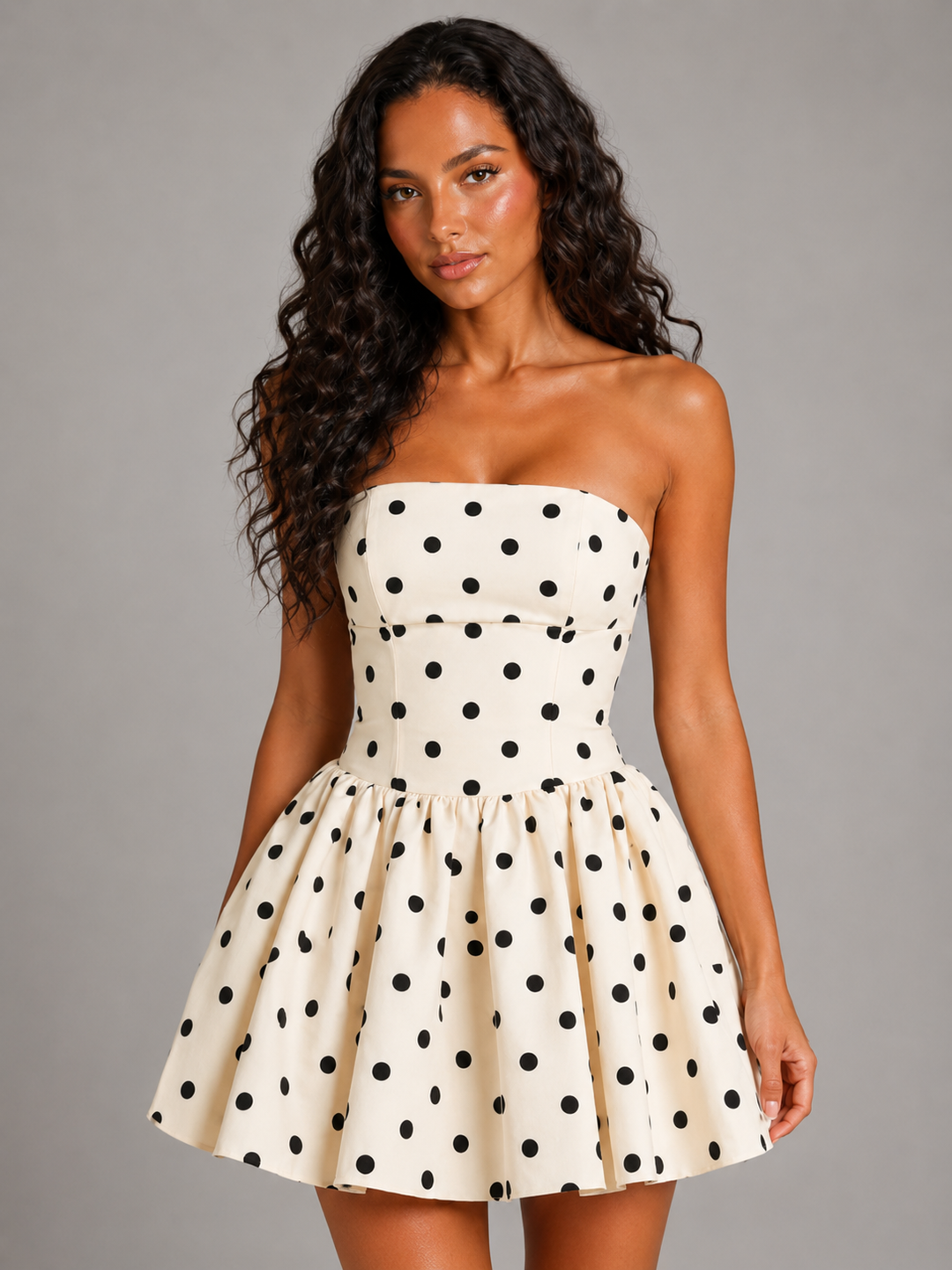 Front view of a women's white strapless polka dot mini dress, a perfect playful retro skater dress for homecoming.
