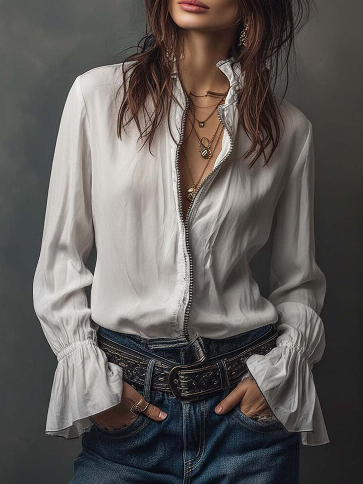 Women's white zip-front blouse with elegant bell cuffs and long sleeves. Perfect versatile tailored top.