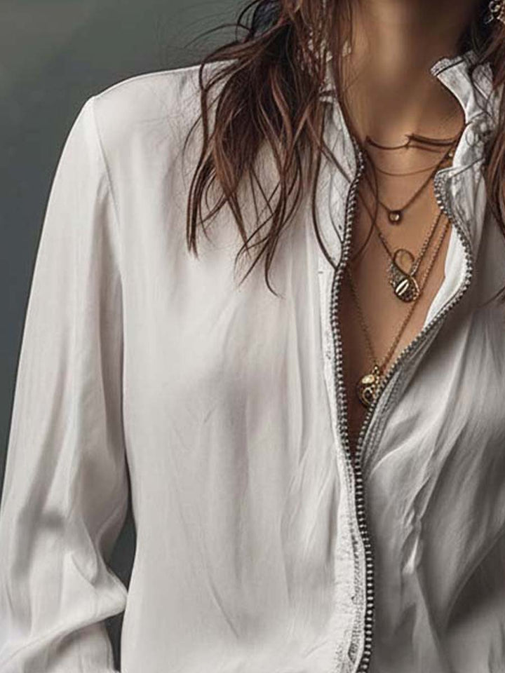 Versatile white zip-front blouse for women, designed with bell cuffs. Great for office or casual chic style.