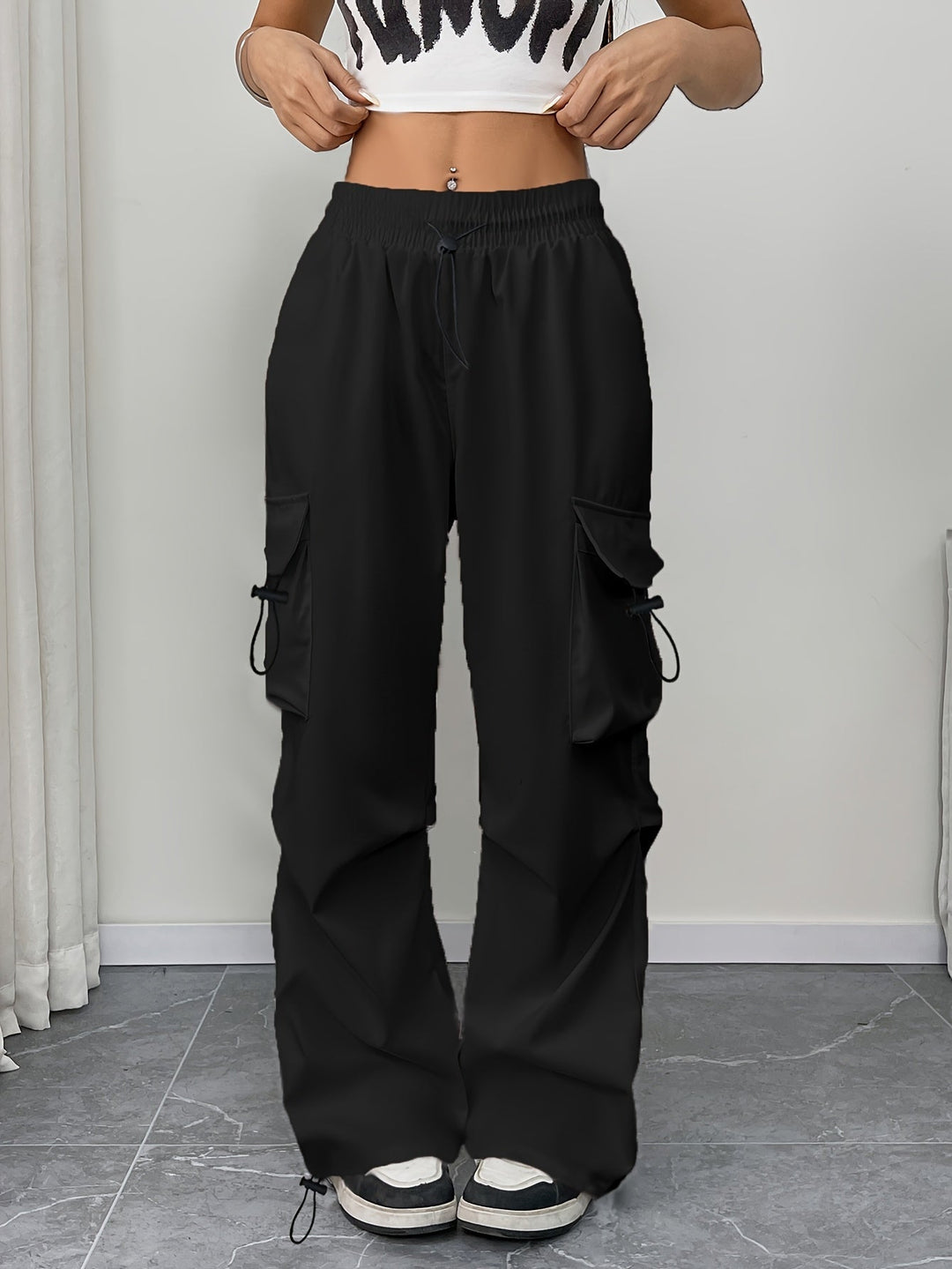 Trendy women's wide leg cargo pants, comfortable drawstring waist, utility pockets. Great for casual wear.