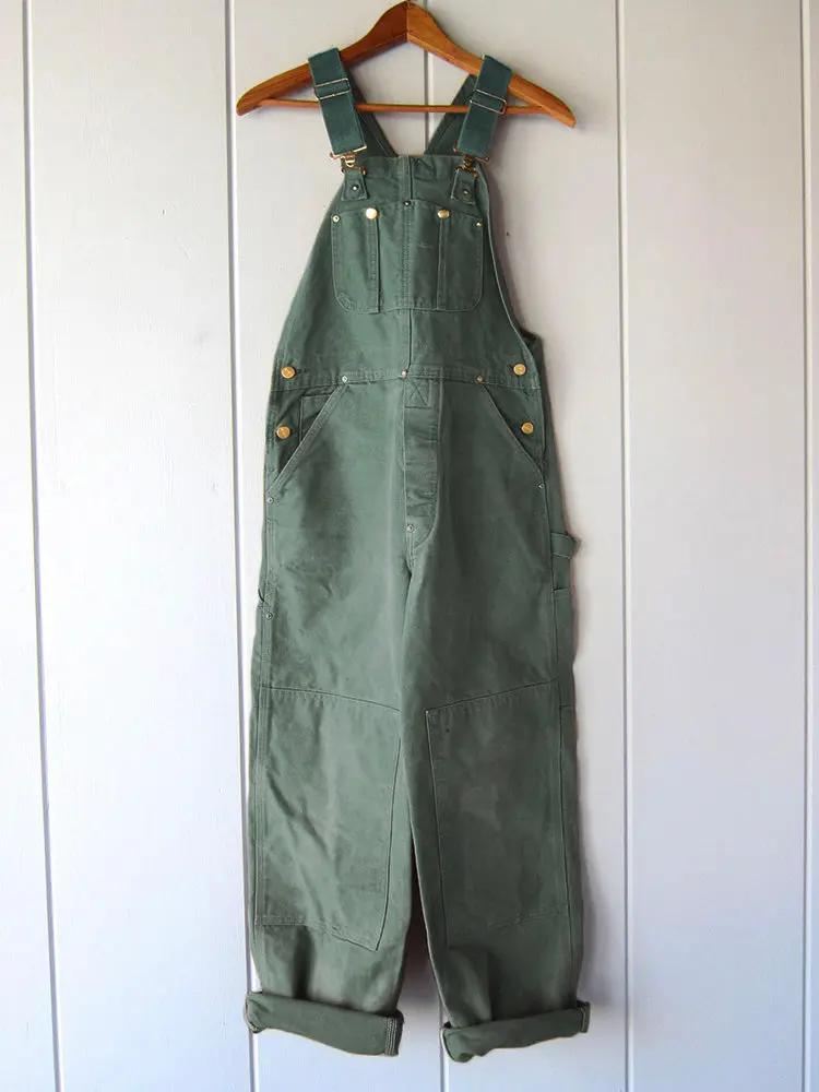 Woman wearing a relaxed fit wide-leg jumpsuit. Comfortable women's overalls with adjustable straps for everyday fashion.