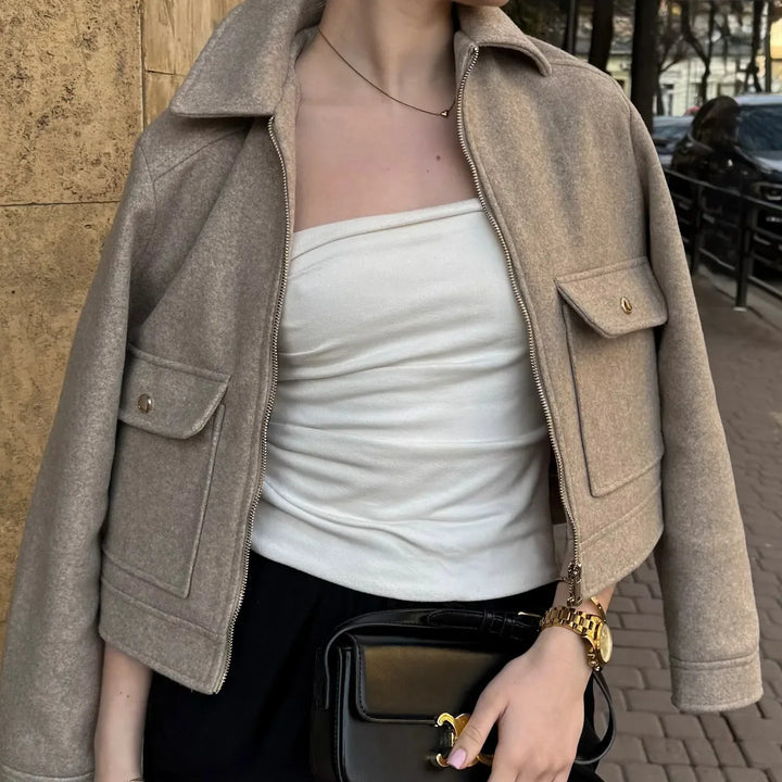 Stylish women's wool bomber jacket, close-up of zipper detail and soft wool texture, ideal for warmth and fashion.