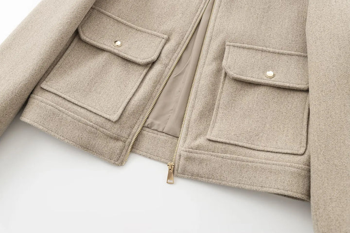 Detail shot of the collar and ribbed cuffs on the women's wool bomber jacket, a cozy winter coat.