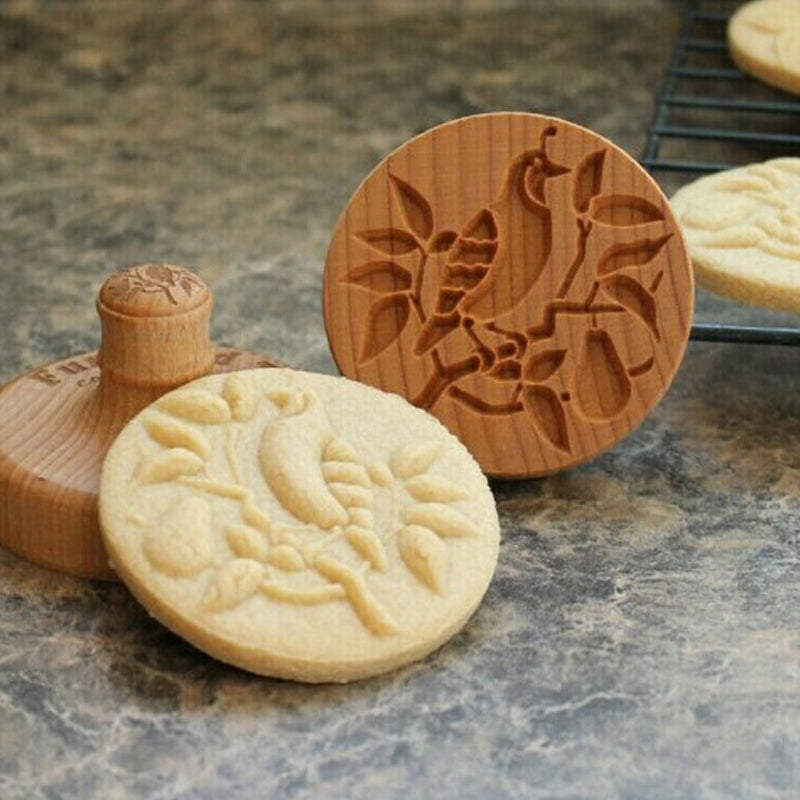 Hand-carved wooden cookie stamp with a unique design, perfect for baking enthusiasts