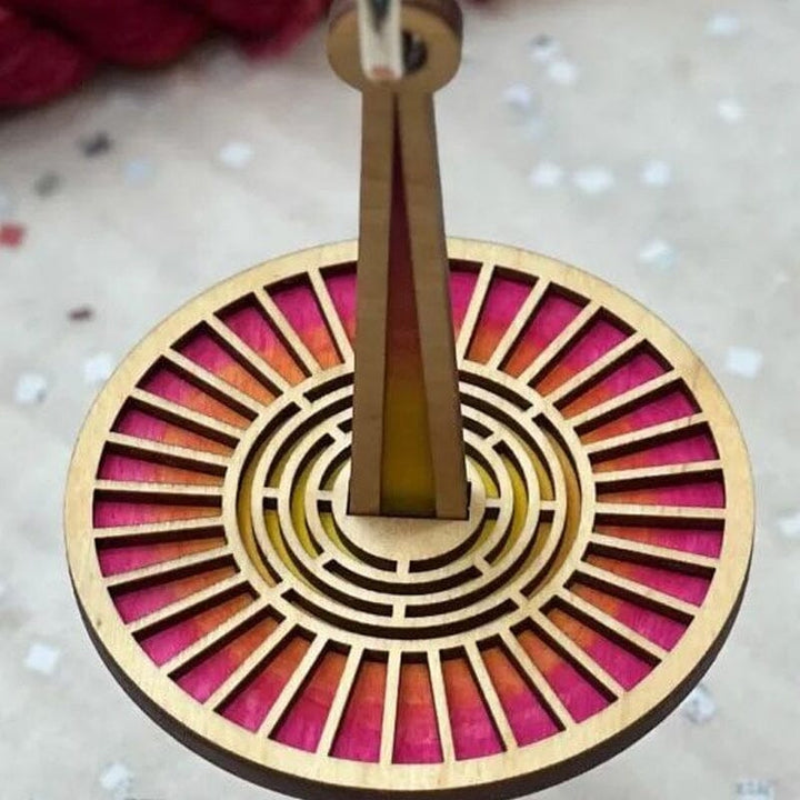 Elegant wooden spinning holder for yarn balls, ideal for DIY craft enthusiasts.