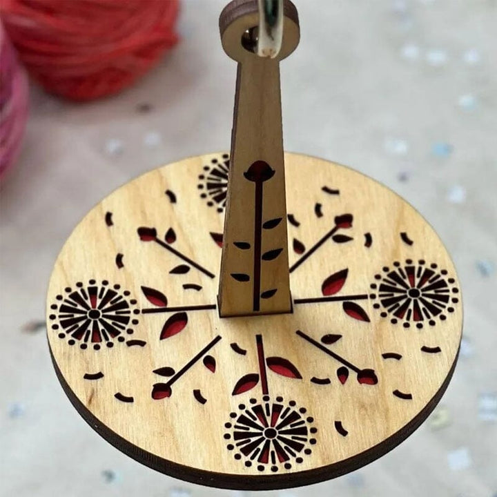 Smooth rotating wooden yarn spindle for effortless and tangle-free crafting sessions.