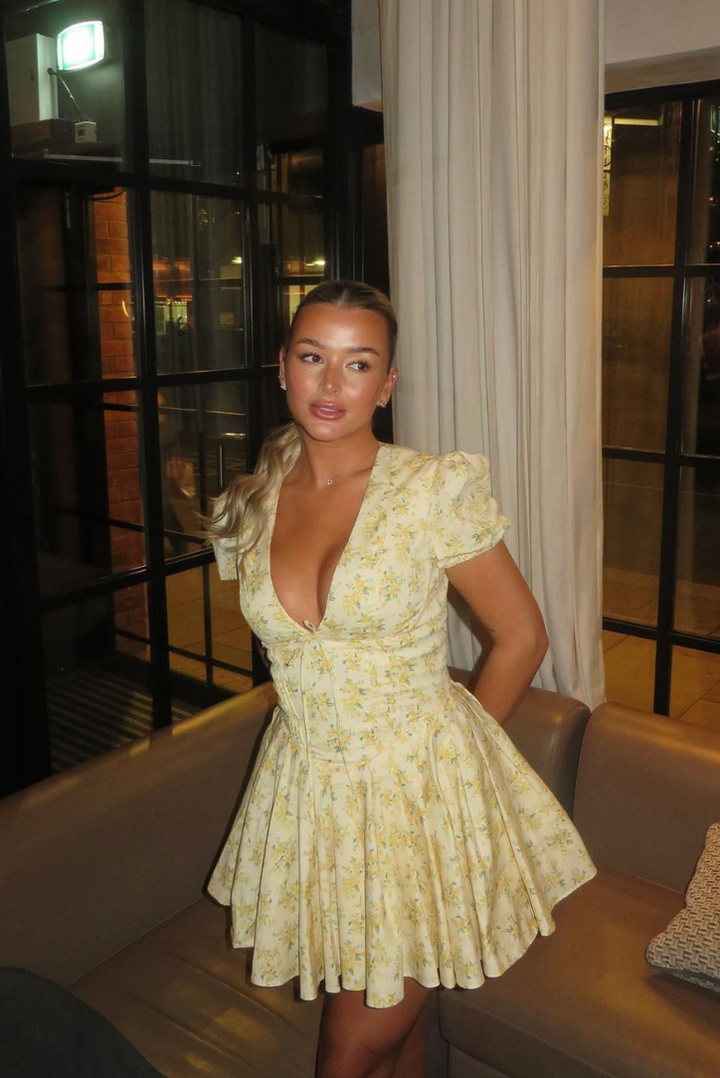 Summer floral mini dress with puff sleeves, open back, A-line cut, perfect for ladies.